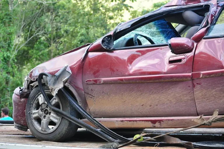Used-car buyer comparing two sedans and checking insurance cost factors on a smartphone